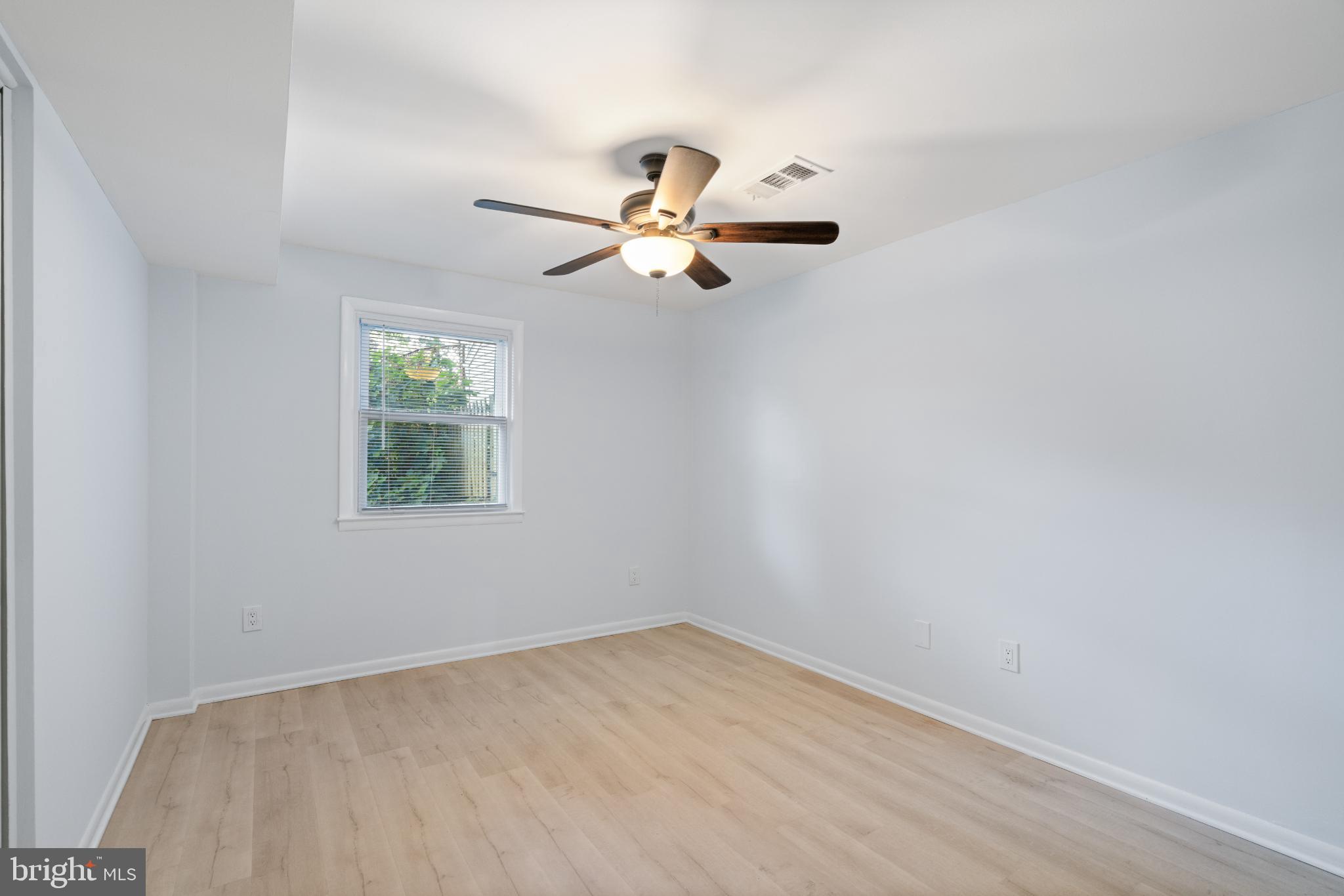7105 Galgate Drive Springfield, VA 22152 - Photo 10 of 36 an empty room with a window and a fan