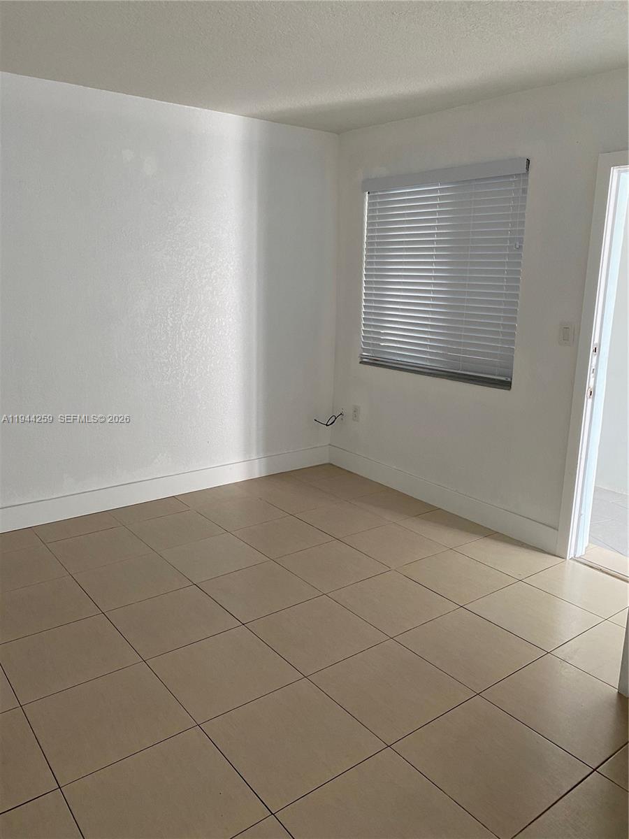 35 Southwest 21st Avenue, Unit 4 Miami, FL 33135 - Photo 6 of 8 an empty room with a empty space and window