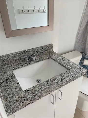 a white toilet sitting next to a bath tub shower