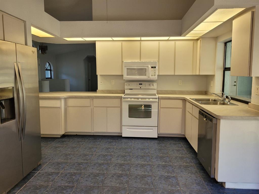 4314 Concert Street Port Charlotte, FL 33948 - Photo 13 of 27 a kitchen with stainless steel appliances a white cabinets and a sink