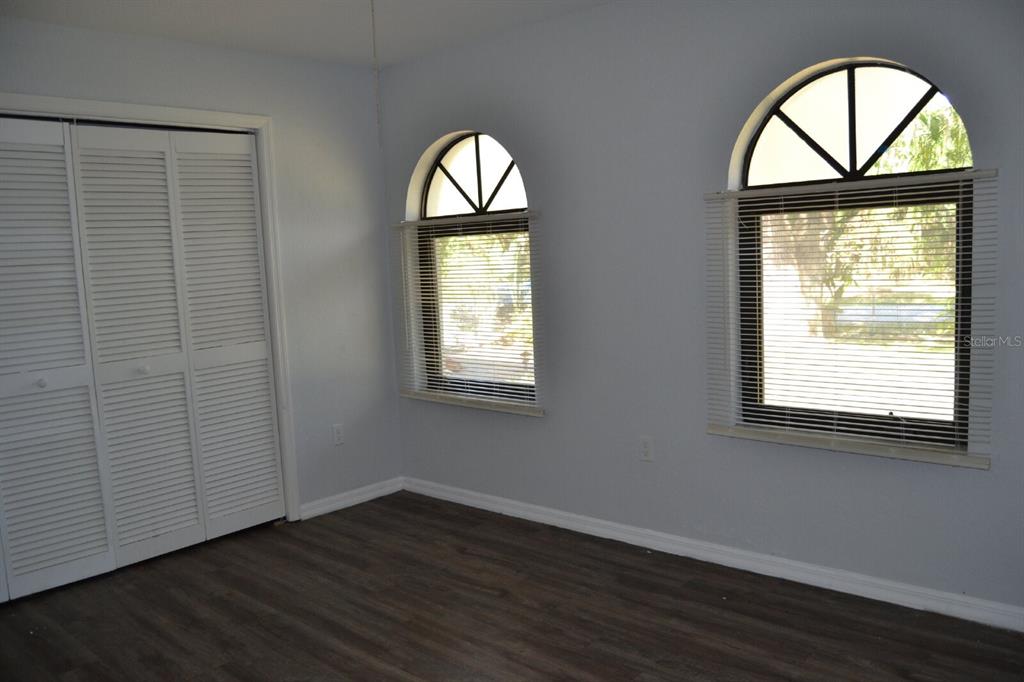 4314 Concert Street Port Charlotte, FL 33948 - Photo 15 of 27 an empty room with wooden floor windows and chandelier