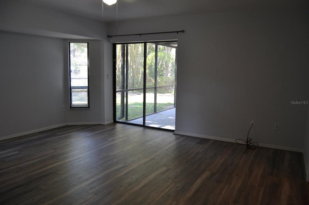 4314 Concert Street Port Charlotte, FL 33948 - Photo 18 of 27 an empty room with wooden floor and windows