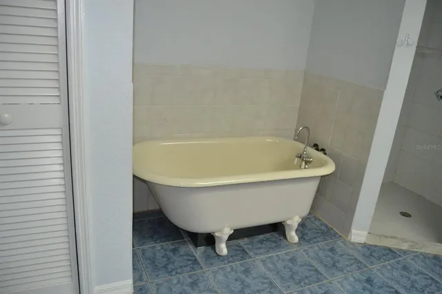 an empty room with wooden floor chandelier and wooden floor