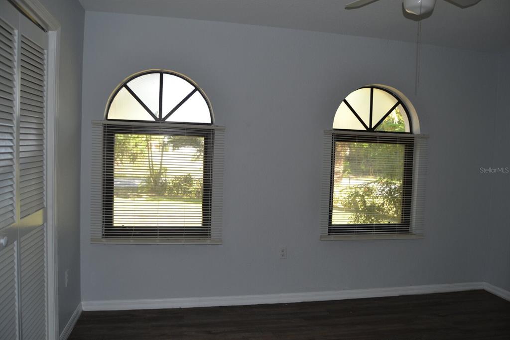 4314 Concert Street Port Charlotte, FL 33948 - Photo 21 of 27 an empty room with wooden floor chandelier and wooden floor
