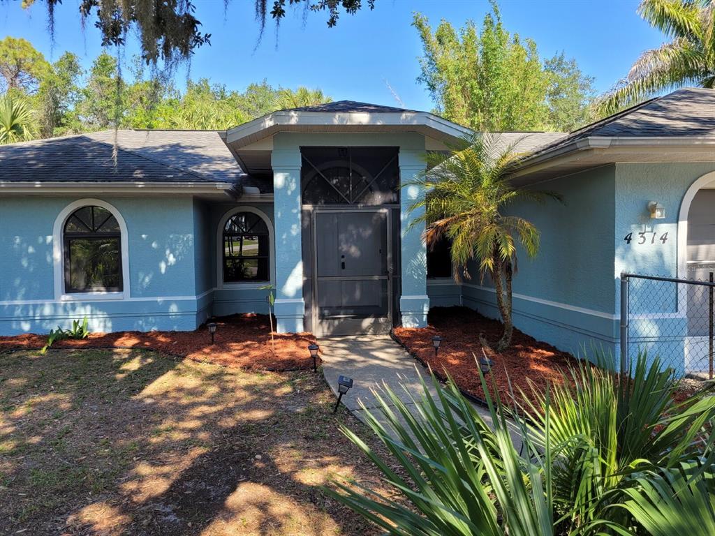 4314 Concert Street Port Charlotte, FL 33948 - Photo 6 of 27 a front view of a house with garden