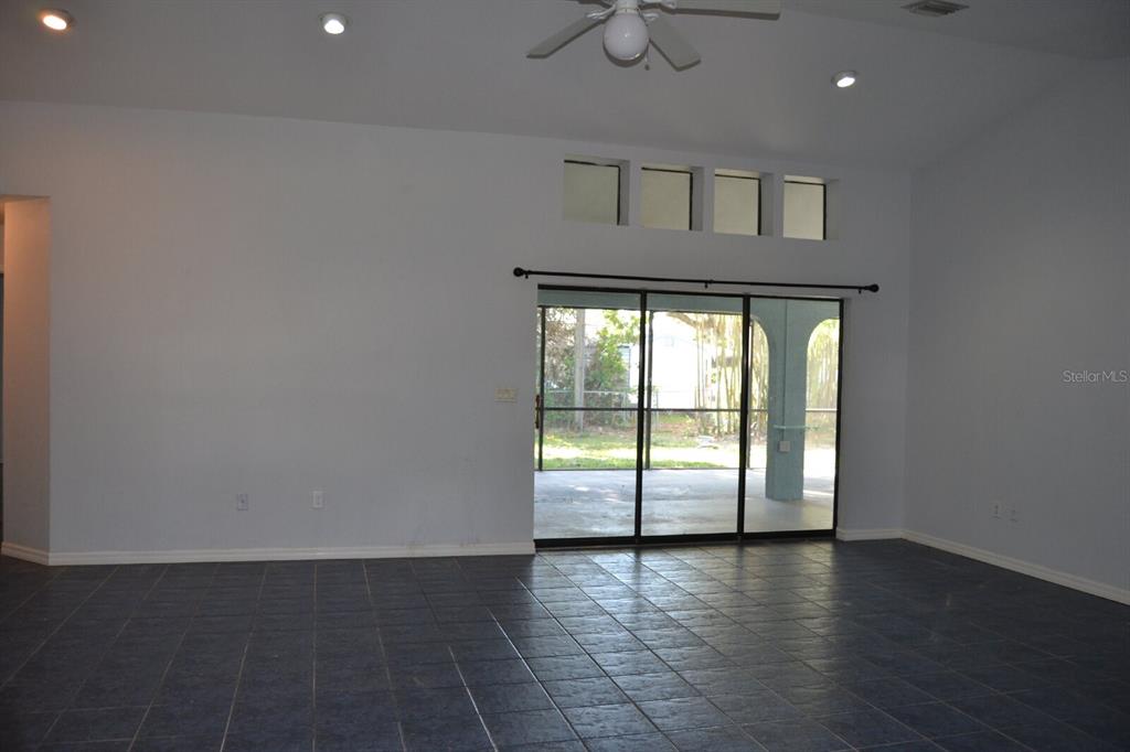 4314 Concert Street Port Charlotte, FL 33948 - Photo 7 of 27 a view of an empty room with wooden floor and a window