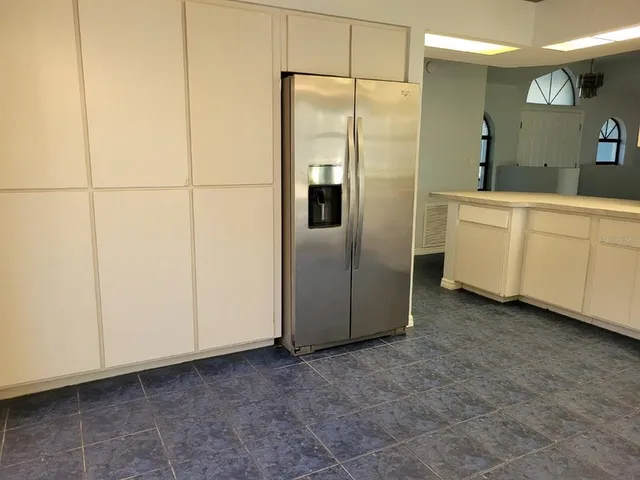 a kitchen with cabinets and stainless steel appliances