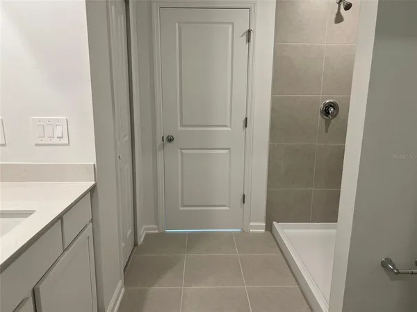 a bathroom with a tub and shower