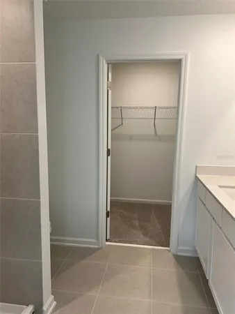 a view of an empty room with closet and wooden floor