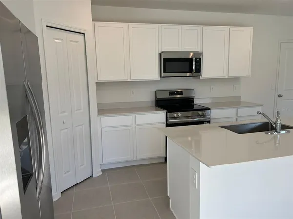 a kitchen with a sink and a stove top oven