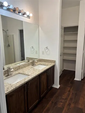 a bathroom with a granite countertop sink and a mirror
