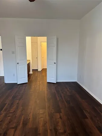 a view of an empty room and wooden floor