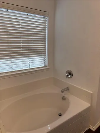 a white bath tub sitting next to a window
