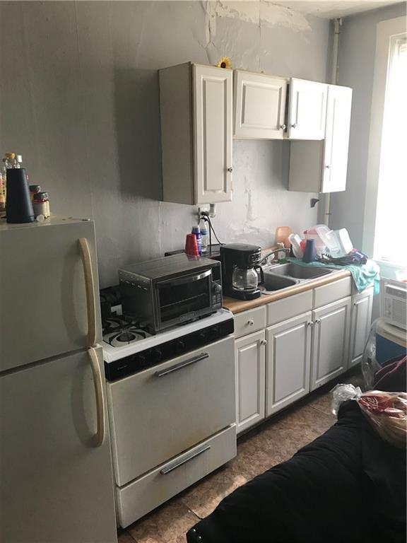 317 Hamilton Street McKees Rocks, PA 15136 - Photo 13 of 38 a kitchen with stainless steel appliances a sink stove and refrigerator