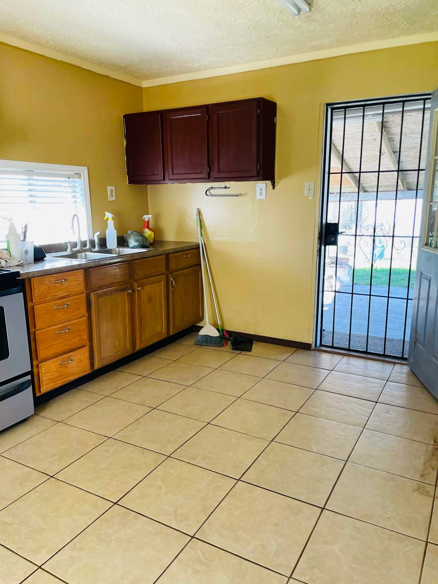 1825 Isom Street Houston, TX 77039 - Photo 16 of 27 a kitchen with stainless steel appliances a stove a sink a counter top space and cabinets