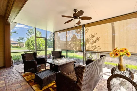 a living room with furniture and a floor to ceiling window