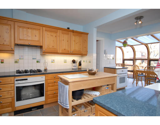 30 Sunset Road Newton, MA 02458 - Photo 11 of 26 a kitchen with stainless steel appliances a stove a sink dishwasher and cabinets with wooden floor