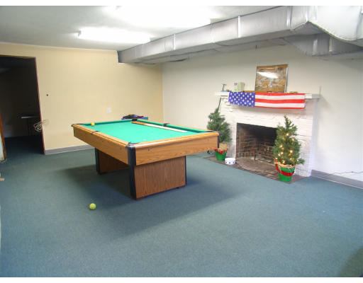 30 Sunset Road Newton, MA 02458 - Photo 21 of 26 a room with pool table a fireplace and a wooden floor