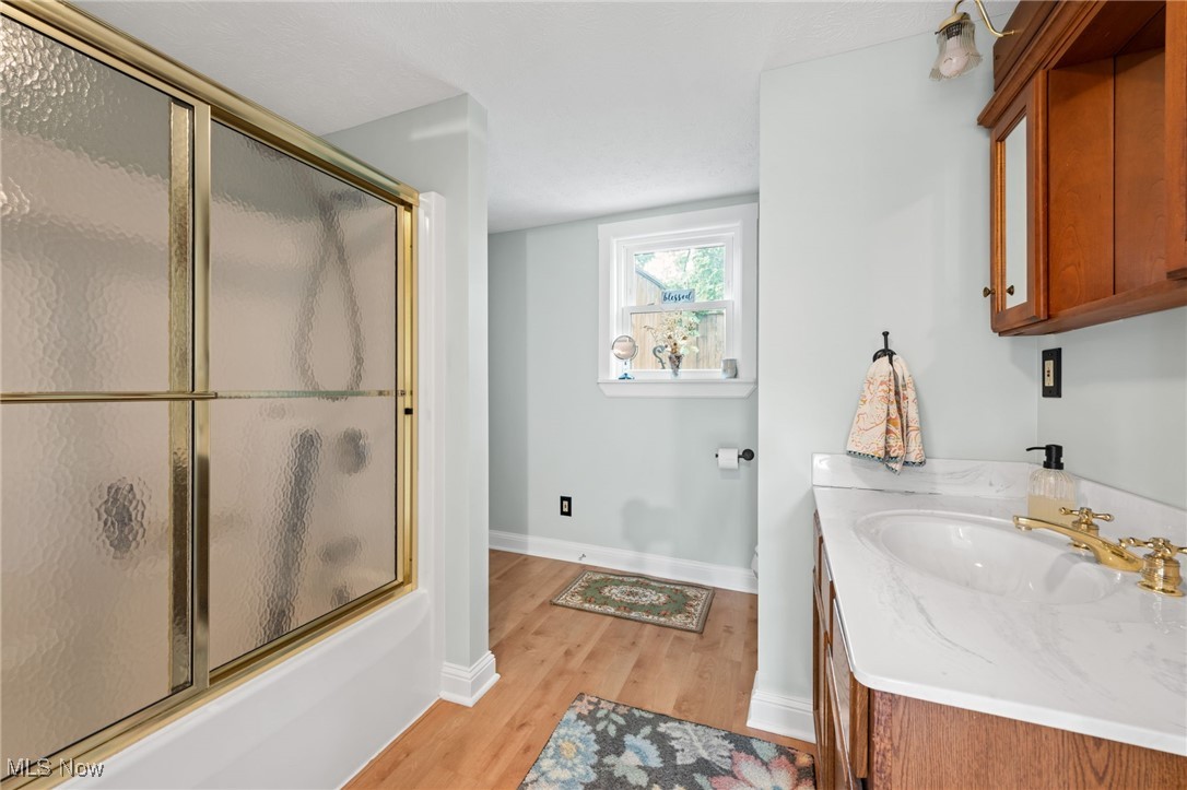 3945 Columbia Road Medina, OH 44256 - Photo 10 of 40 Full bath featuring wood finished floors, vanity, and enclosed tub / shower combo