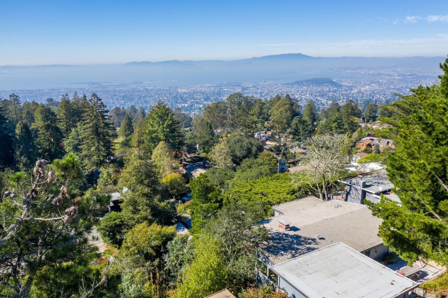 1384 Summit Road Berkeley, CA 94708 - Photo 18 of 31 an aerial view of a city with lots of residential buildings and mountain view in back
