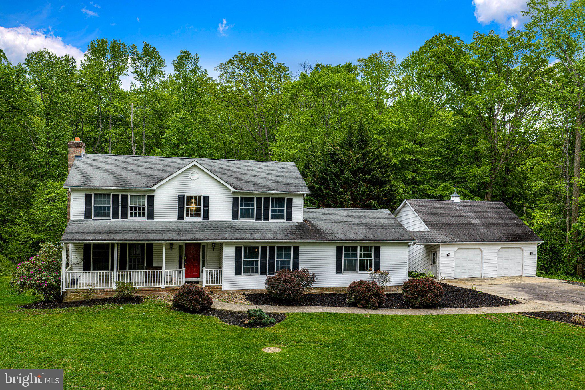 711 Gilbert Road Aberdeen, MD 21001 - Photo 35 of 54 a front view of a house with a garden and trees