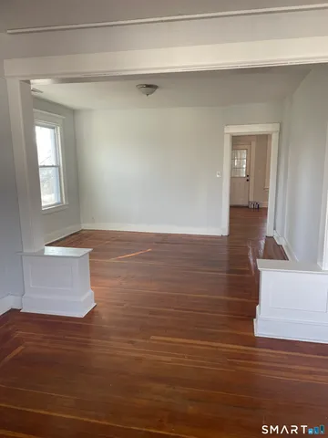 a view of wooden floor and windows in a room