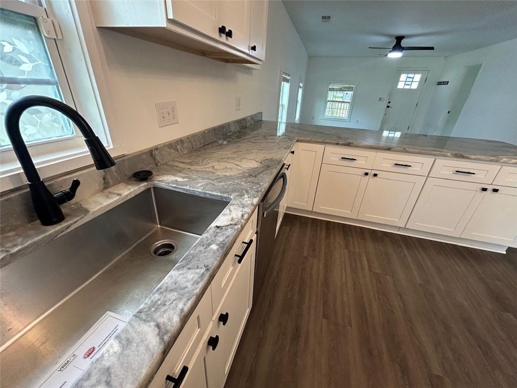 4495 Calhoun Road Northeast Rome, GA 30161 - Photo 7 of 14 a kitchen with a sink stove and cabinets