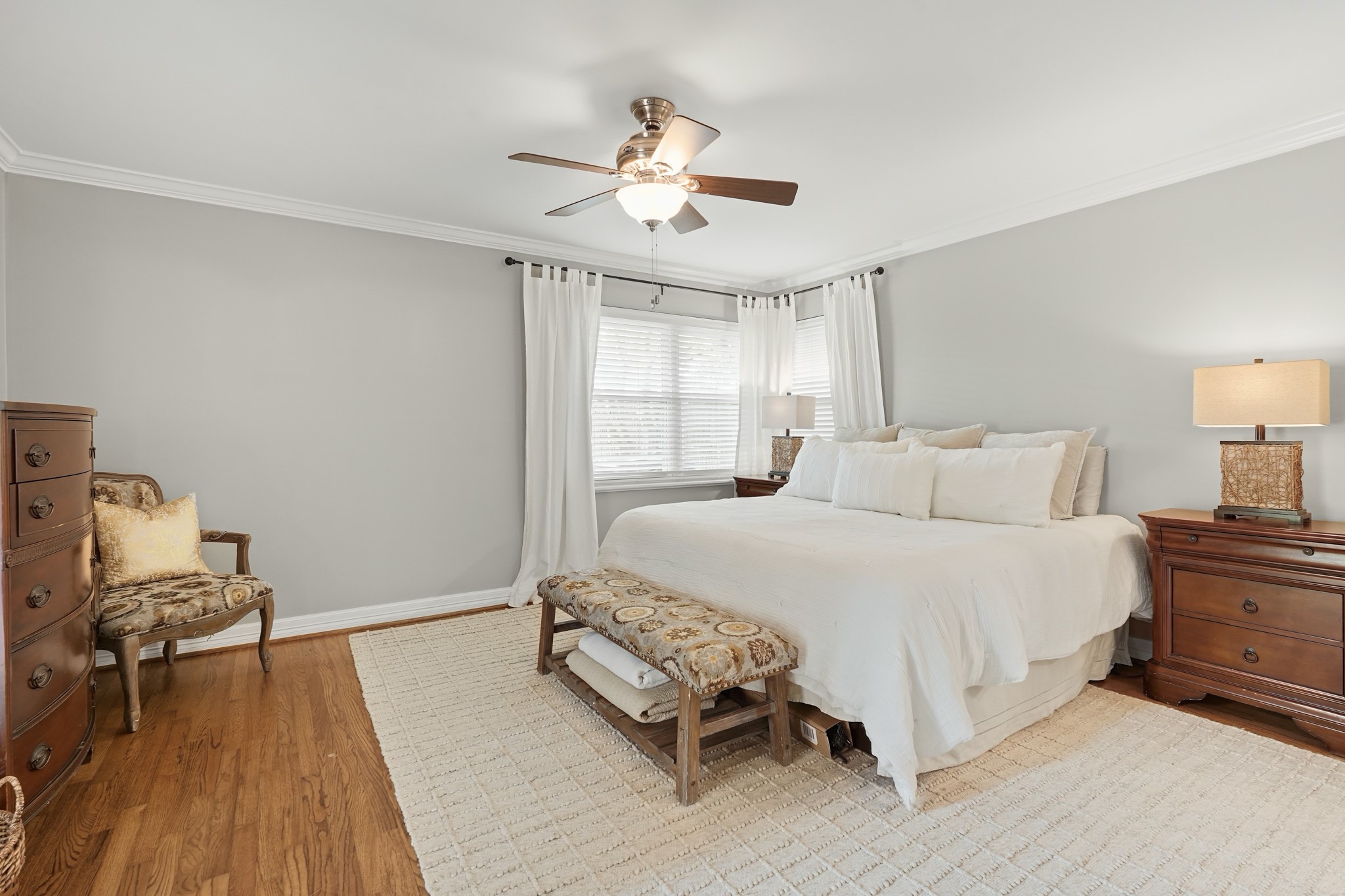 5242 Sanford Road Houston, TX 77035 - Photo 17 of 34 This is a spacious primary bedroom with plenty of space, walk in closet, and lots of natural light. The room is accented with a ceiling fan, hardwood floors, and French door for easy access outside to the backyard!