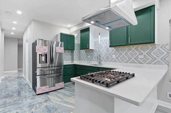 a kitchen with stainless steel appliances granite countertop a sink stove and refrigerator