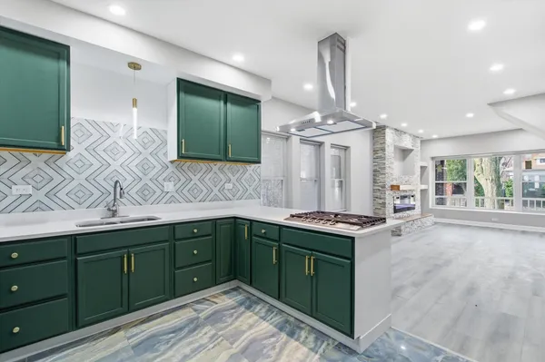a kitchen with stainless steel appliances granite countertop a sink and cabinets