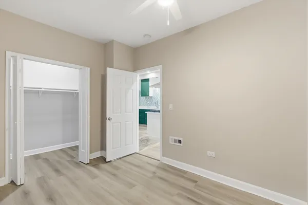 an empty room with closet and windows