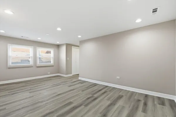 wooden floor in an empty room with windows