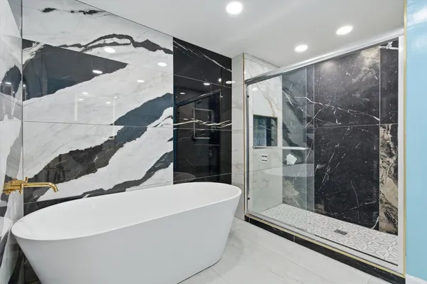 a bathroom with a bathtub and a shower