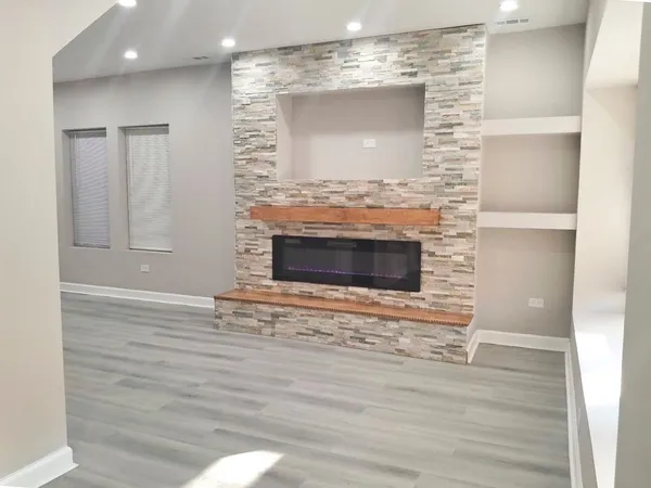 a view of fireplace and wooden floor