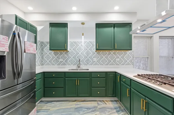 a kitchen with a sink and refrigerator