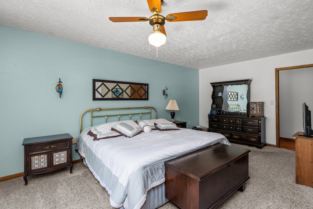 11213 22nd Street Milan, IL 61264 - Photo 15 of 36 a bedroom with a bed a ceiling fan and a dresser
