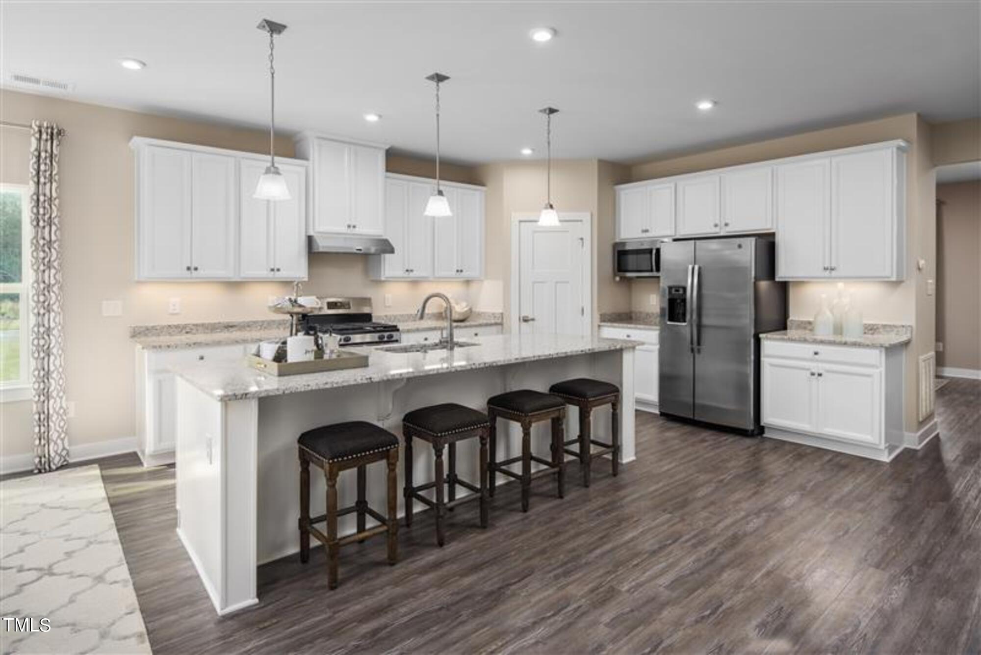 540 Impala Trace Wendell, NC 27591 - Photo 2 of 14 a kitchen with stainless steel appliances granite countertop a refrigerator a sink dishwasher a stove and white cabinets with wooden floor