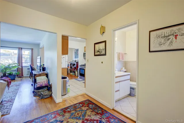 a view of a hallway with wooden floor and furniture