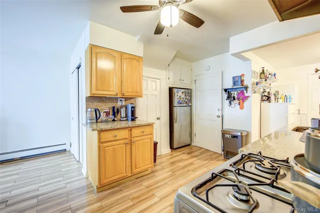 a kitchen with stainless steel appliances granite countertop a stove and a refrigerator