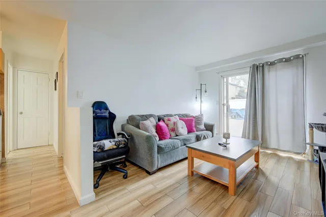 a living room with a couch and a wooden floor