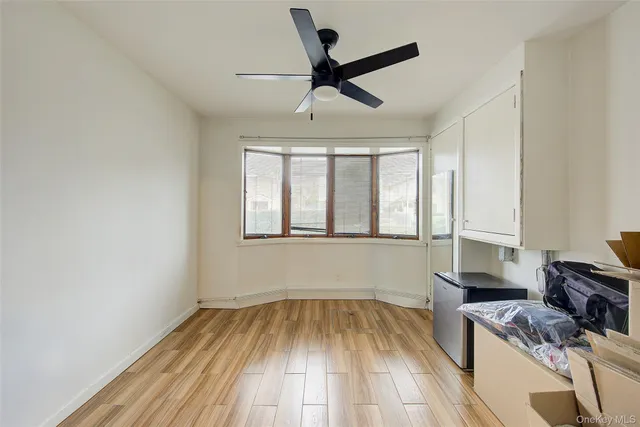 a view of kitchen with a sink wooden floor and a window