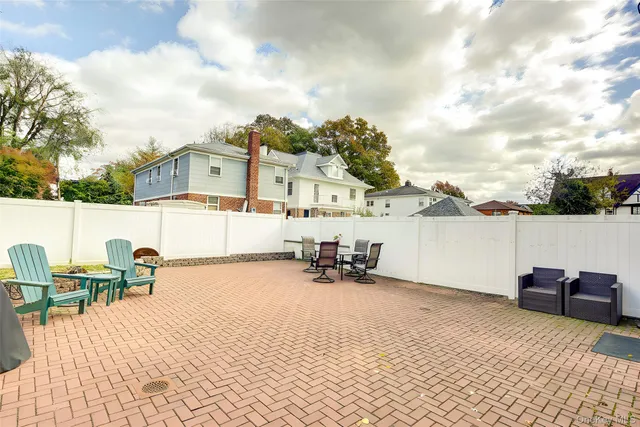 a view of a patio with dining table and chairs with wooden floor