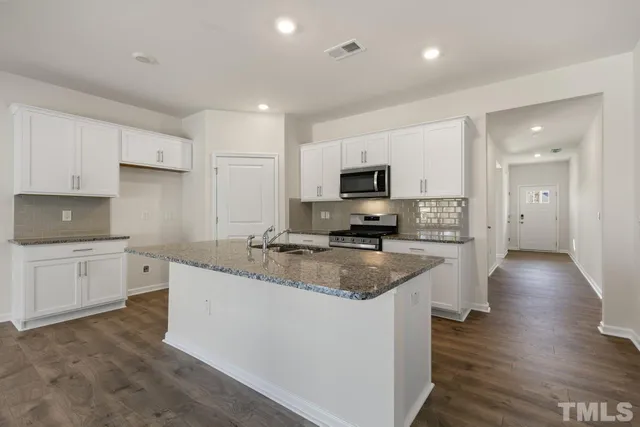 a view of kitchen with wooden floor and electronic appliances