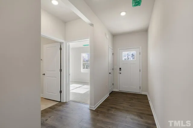 a view of an entryway with wooden floor