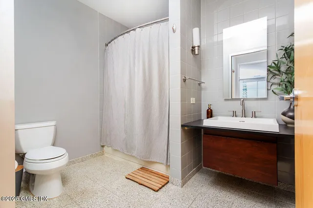 a bathroom with a sink toilet and shower