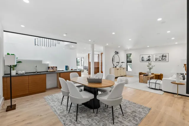 a dining room with furniture and wooden floor