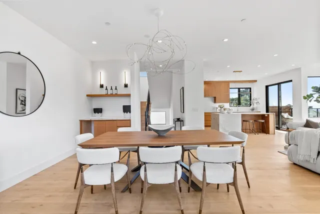 a dining room with granite countertop a table and chairs