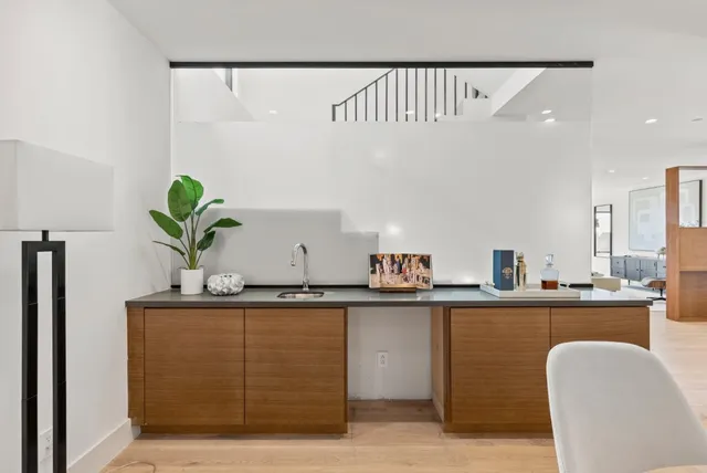 a kitchen with a sink cabinets and wooden floor