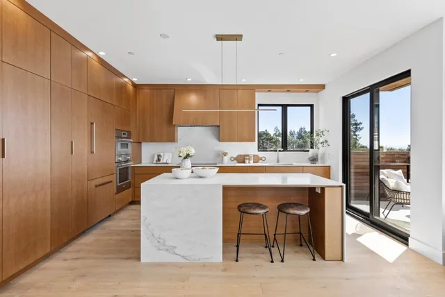 a kitchen with stainless steel appliances granite countertop a sink and a refrigerator