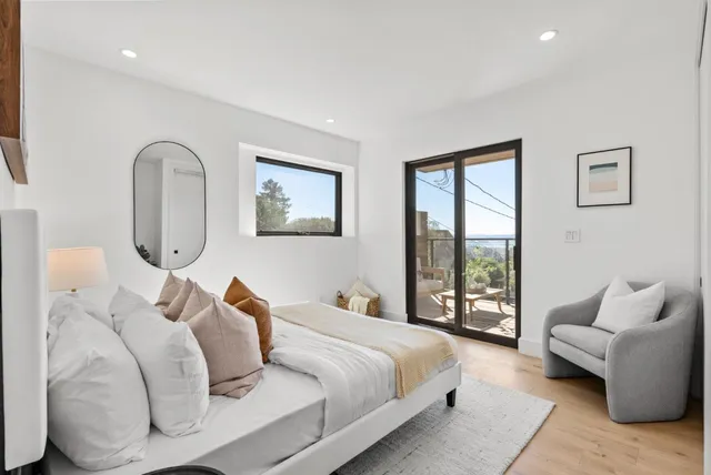 a bedroom with a large bed and a couch